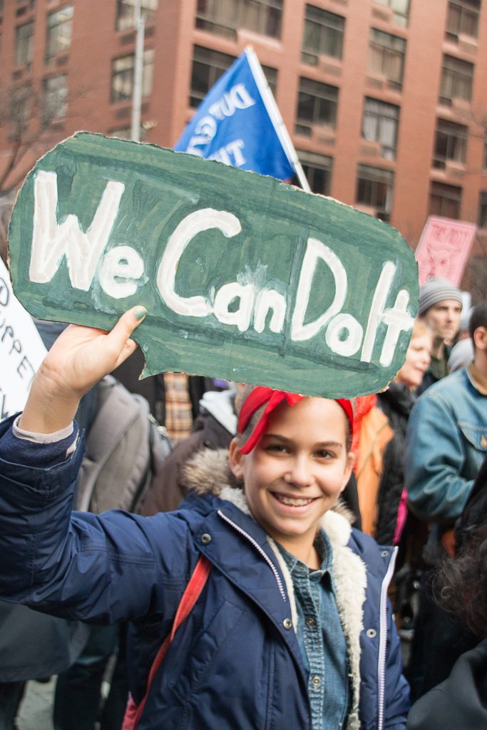 A young woman, dressed in costume as the famous "We Can Do It!" poster at the New York City Women's March